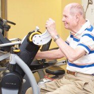 Arm Bike with older man at Optimum Performance Physical Therapy